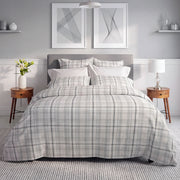 Grayson grey plaid flannel duvet cover and shams styled on a bed with grey upholstered headboard – warm cozy flannel bedding by Cuddle Down